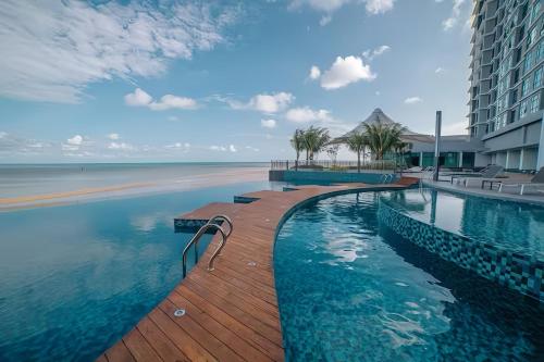 a swimming pool with a view of the ocean at Imperium Residence Kuantan in Kuantan