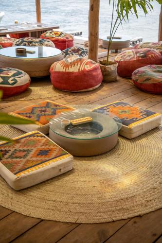 a wooden table with many different colored cushions on it at Temple Point Resort in Watamu
