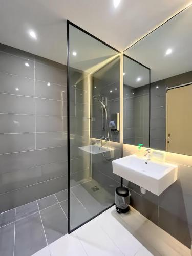 a bathroom with a sink and a glass shower at Imperium Residence Kuantan in Kuantan