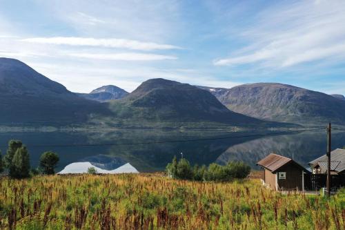 a view of a lake and mountains with a house at Seljeli - aktiv fritid in Alta