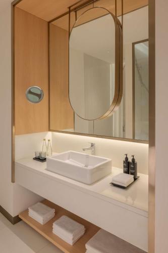 a bathroom with a sink and a mirror at Radisson Collection Resort Galle in Galle