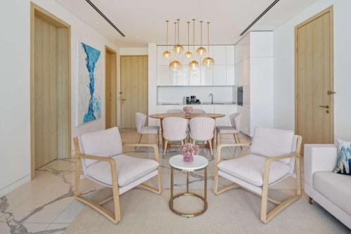 a kitchen and dining room with a table and chairs at Radisson Collection Resort Galle in Galle