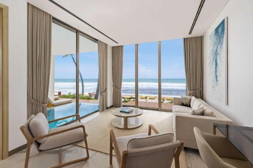 a living room with a view of the ocean at Radisson Collection Resort Galle in Galle