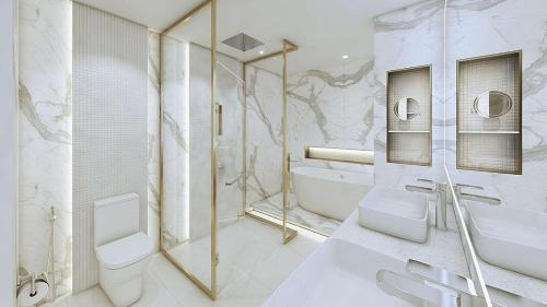 a bathroom with a toilet and a tub and a sink at Radisson Collection Resort Galle in Galle