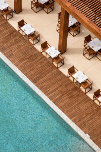 an overhead view of a pool with tables and chairs at Radisson Collection Resort Galle in Galle