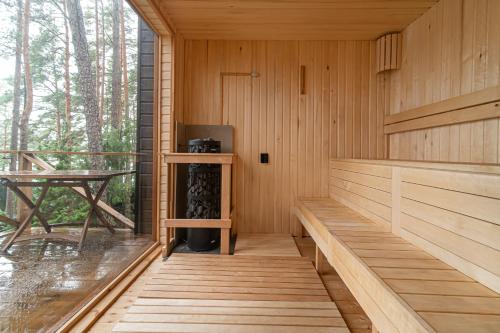 a sauna with wood paneling and a table at Villa Green in Molėtai