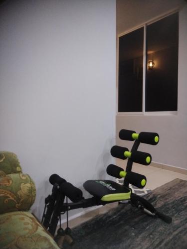 a room with two exercise chairs and a couch at Kenangan Homestay Kemaman in Kampong Chendar