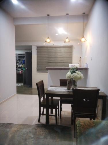 a dining room with a table and chairs at Kenangan Homestay Kemaman in Kampong Chendar