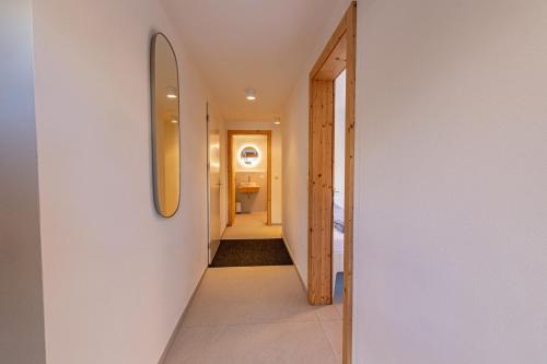 a hallway of a house with a mirror on the wall at Luxury Penthouse Sonnenhof in Saas-Fee