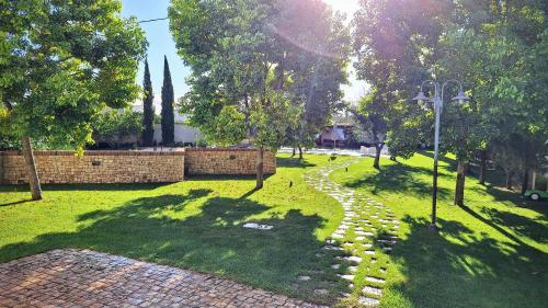 a park with a stone path in the grass at BORGO LUNA b&b in Manduria