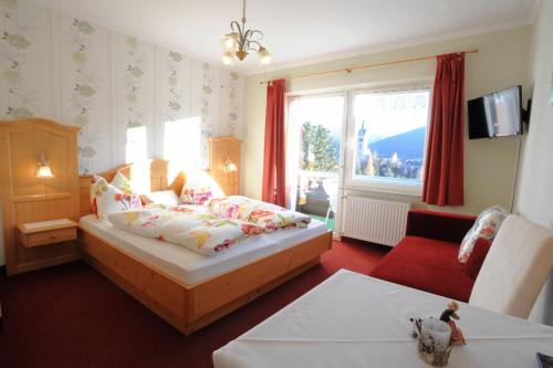 a bedroom with a bed and a living room at Haus Alpina in Radstadt