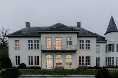 a large white house with windows and a balcony at B&B Kasteel Den Tip in Arendonk