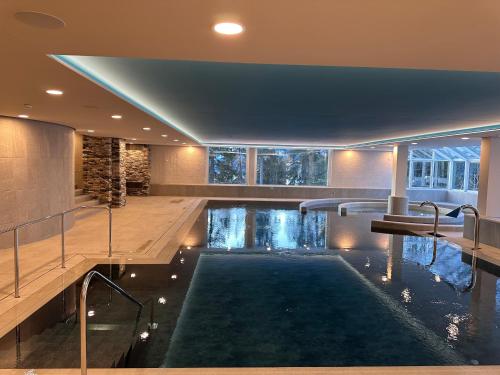 an indoor pool in the middle of a house at Hotel Valaisia Crans Montana, a Faern Collection Resort in Crans-Montana