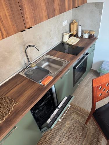 a small kitchen with a sink and a stove at Villa Nada, Apartman Vučko, Divčibare in Divčibare