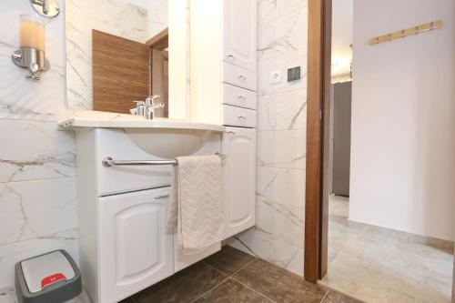 a bathroom with a sink and a mirror at Apartment ErMa in Zaton