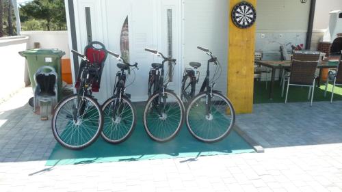 four bikes are lined up against a wall at Apartment ErMa in Zaton