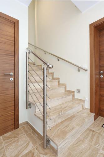 a staircase in a house with a metal railing at Apartment ErMa in Zaton