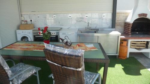 a kitchen with a table and a sink and a stove at Apartment ErMa in Zaton