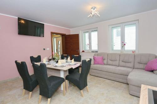a living room with a table and a couch at Apartment ErMa in Zaton