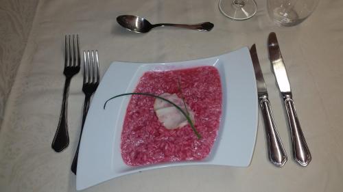 a plate of food on a table with fork and knife at Osteria Anzonico in Anzonico