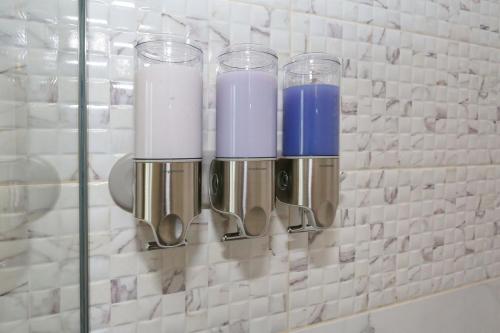a row of wine glasses and spoons on a wall at Apartment ErMa in Zaton