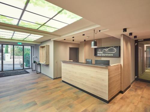 a lobby with a reception desk and a skylight at Hotel Bad Dürkheim in Bad Dürkheim
