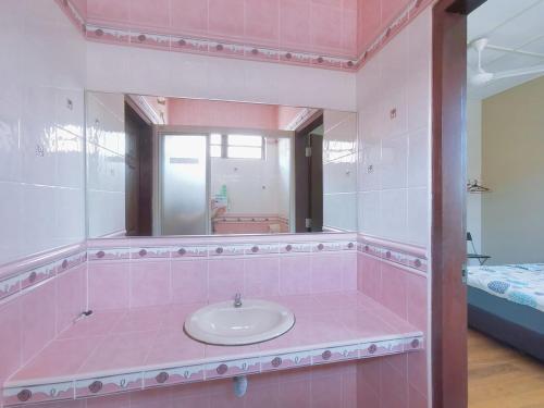 a pink bathroom with a sink and a mirror at Kuantan Air Putih 4 rooms 3 bathrooms Town area in Kuantan