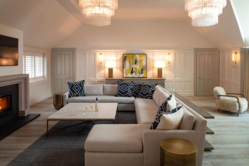 a living room with a couch and a fireplace at Muirfield Green in Gullane
