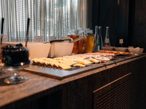 a table with a tray of food on a table at Urban Hotel & Spa Aix-les-Bains - BW Signature Collection in Aix-les-Bains