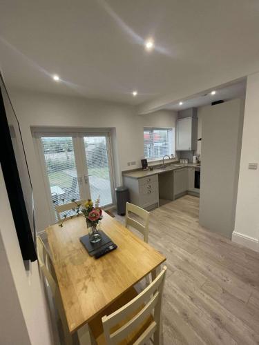 a kitchen and dining room with a table and chairs at The Crescent-Modern Coastal Home in Blackpool