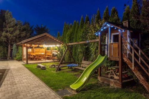 a playground with a slide and a house at Rodzinny zakątek "U Głuszków" Bieszczady in Myczkowce
