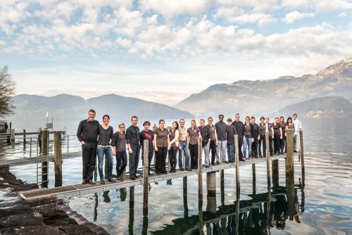 a group of men standing on a dock on the water at Superior Hotel Nidwaldnerhof in Beckenried