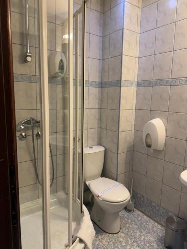 a bathroom with a toilet and a glass shower at Motel M Vlasenica in Vlasenica