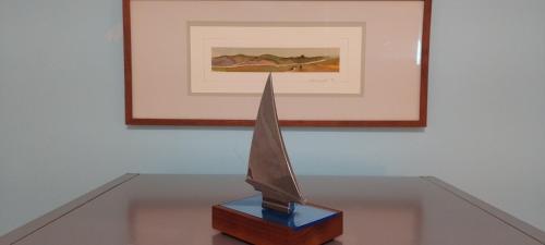 a bronze trophy on a table in front of a picture at BlueJay Room in Boston