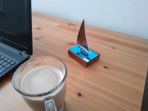 a cup of coffee next to a laptop on a desk at BlueJay Room in Boston