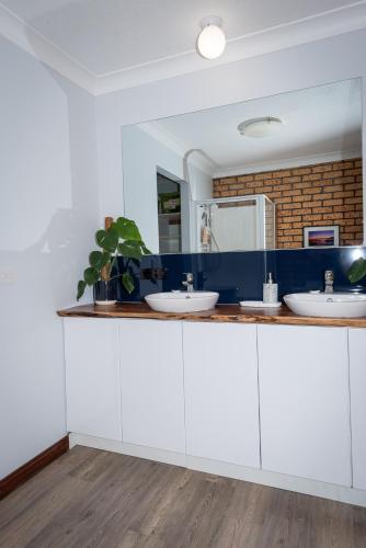 a bathroom with white cabinets and two sinks at Anchors Away in Bicheno
