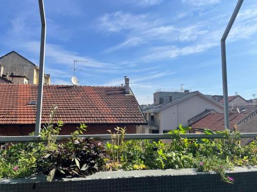 a view of roofs of buildings with plants at Attico Rebecca in Turin