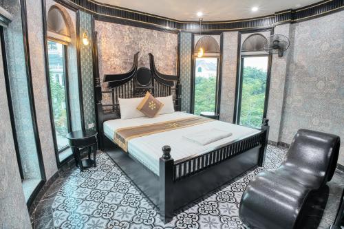 a bedroom with a bed and a chair in it at Bao Ngọc Hotel Dương Nội in Hanoi