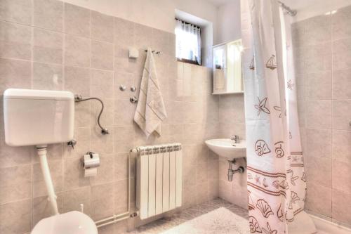 a bathroom with a toilet and a sink at Apartments Grozdana in Baška