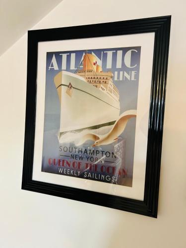 a framed picture of a cruise ship hanging on a wall at Wendys house in Sarisbury Green