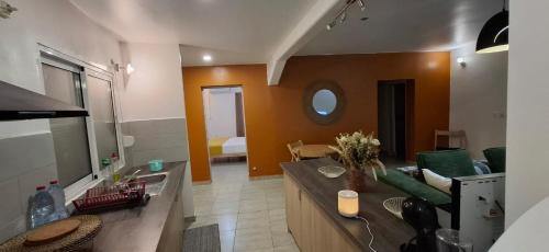 a kitchen and living room with a couch and a table at Modern T3 apartement Mamoudzou in Mamoudzou