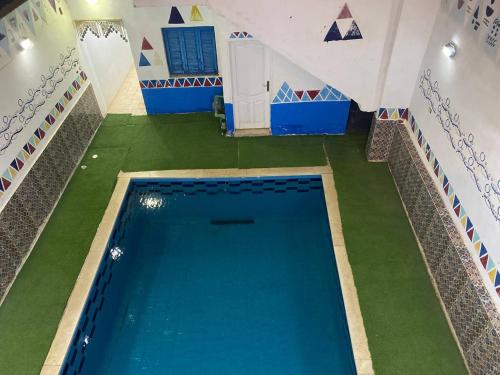 an overhead view of a swimming pool with green grass at Bakar House in Aswan
