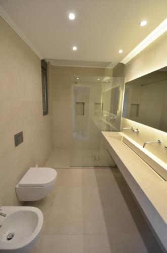 a bathroom with a toilet and a sink and a tub at Villa Kira in Parga