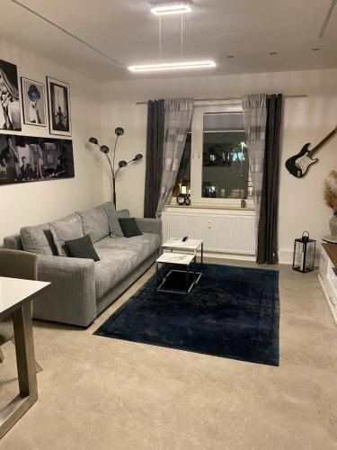 a living room with a couch and a table at City Deluxe Apartment in Hannover