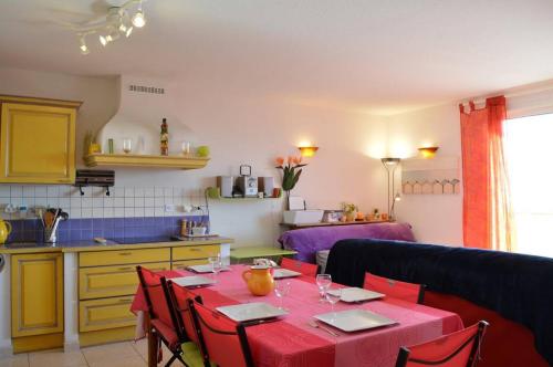 une cuisine avec une table et un chiffon rouge dans l'établissement SP450-052 Mais 3 pièces 6 couchages SAINT PIERRE LA MER, à Saint Pierre La Mer