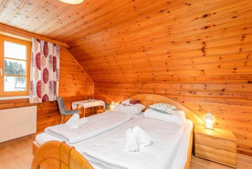 a bedroom with a bed in a wooden room at Matzling Apartment - by myNests in Mitterberg-Schladming-Dachstein