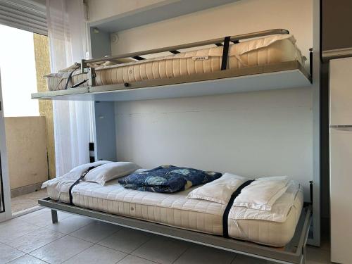 a bedroom with two bunk beds in a room at SP350-208 Appartement Studio 4 couchages SAINT PIERRE LA MER in Saint Pierre La Mer