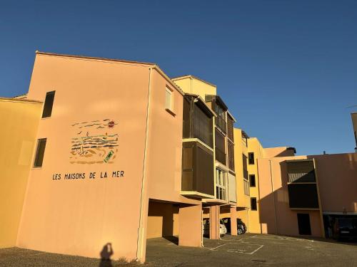 a building with a sign on the side of it at SP350-208 Appartement Studio 4 couchages SAINT PIERRE LA MER in Saint Pierre La Mer