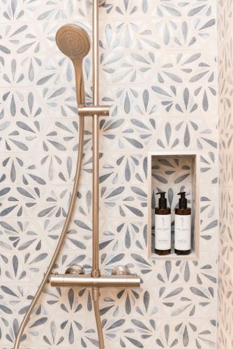 a bathroom with a towel rack with two bottles of wine at Magazin Rooms in Salzburg