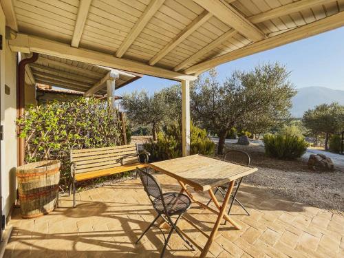 a picnic table and a bench on a patio at Pietra Pizzuta Country House in Torre deʼ Passeri